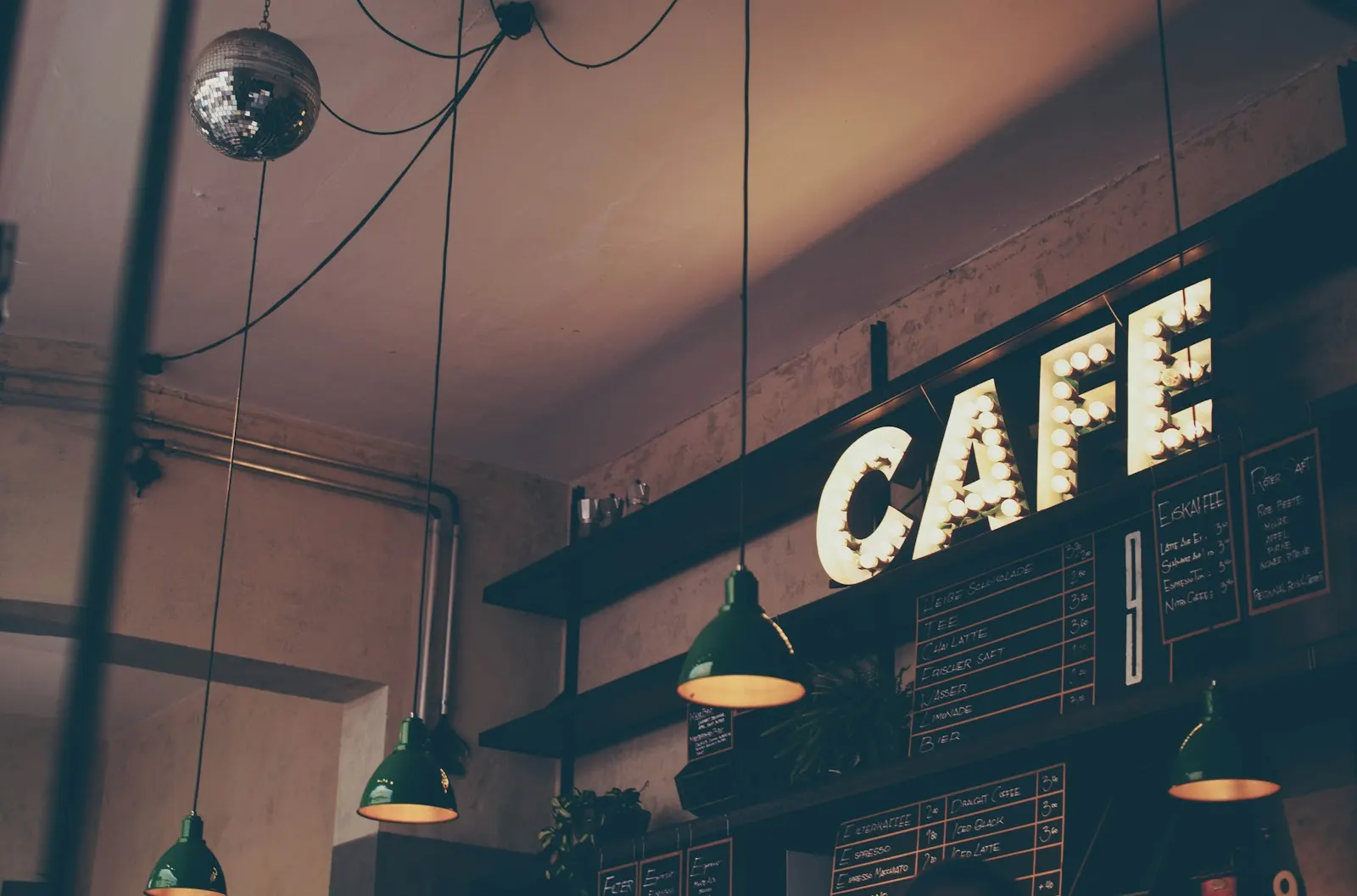 A café sign glowing above the counter