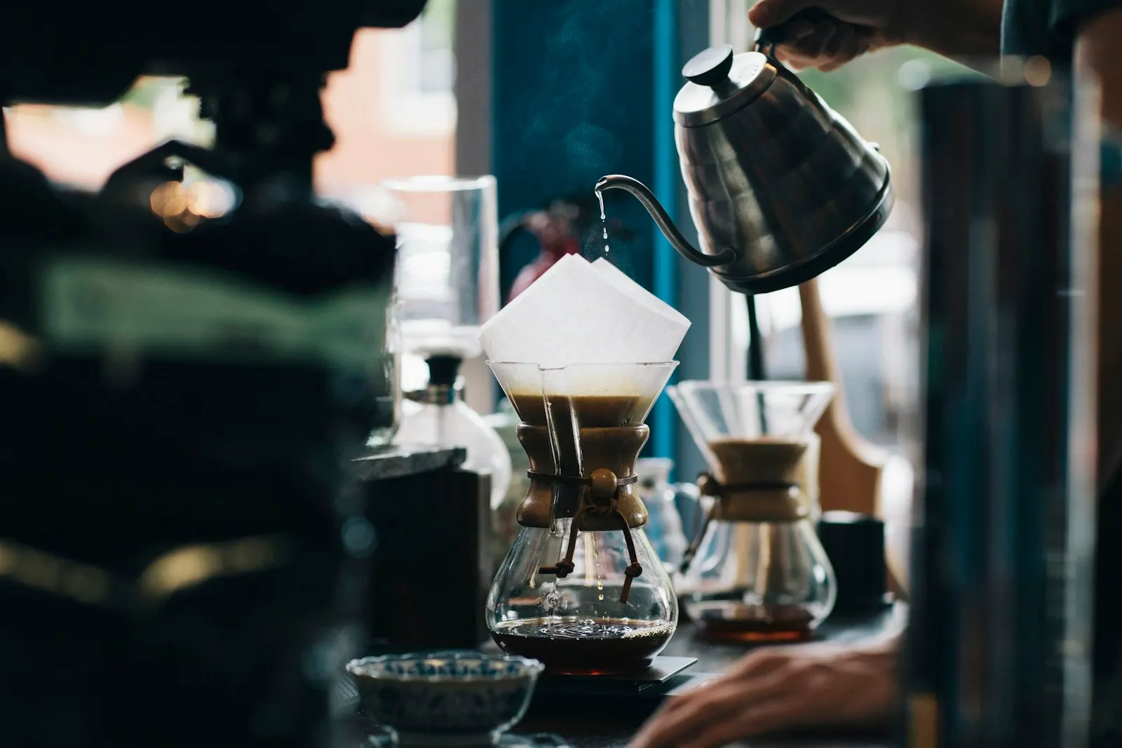 Pour-over coffee being made at a dim espresso bar