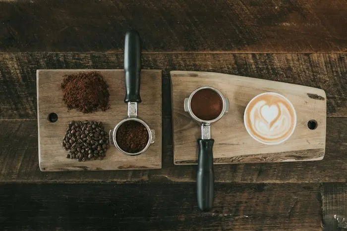 Coffee beans, fresh grounds and a portafilter